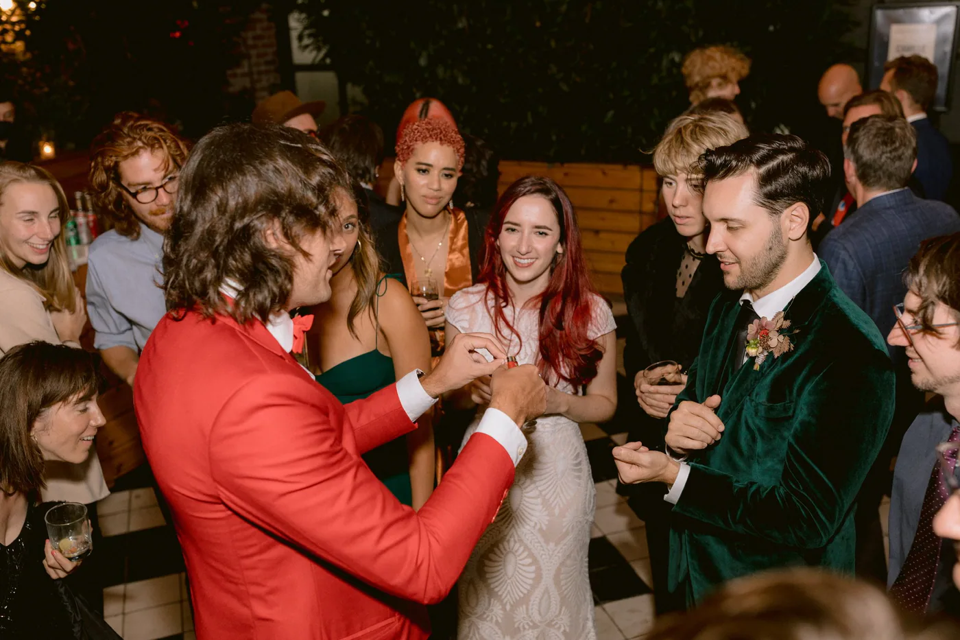 Guests watching close-up magic during a wedding celebration